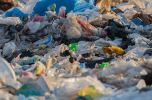 A mountain of plastic trash of all colors is shown