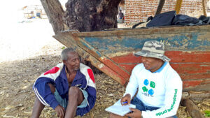 A Rare staff member interviews a fisherman in Mozambique. 